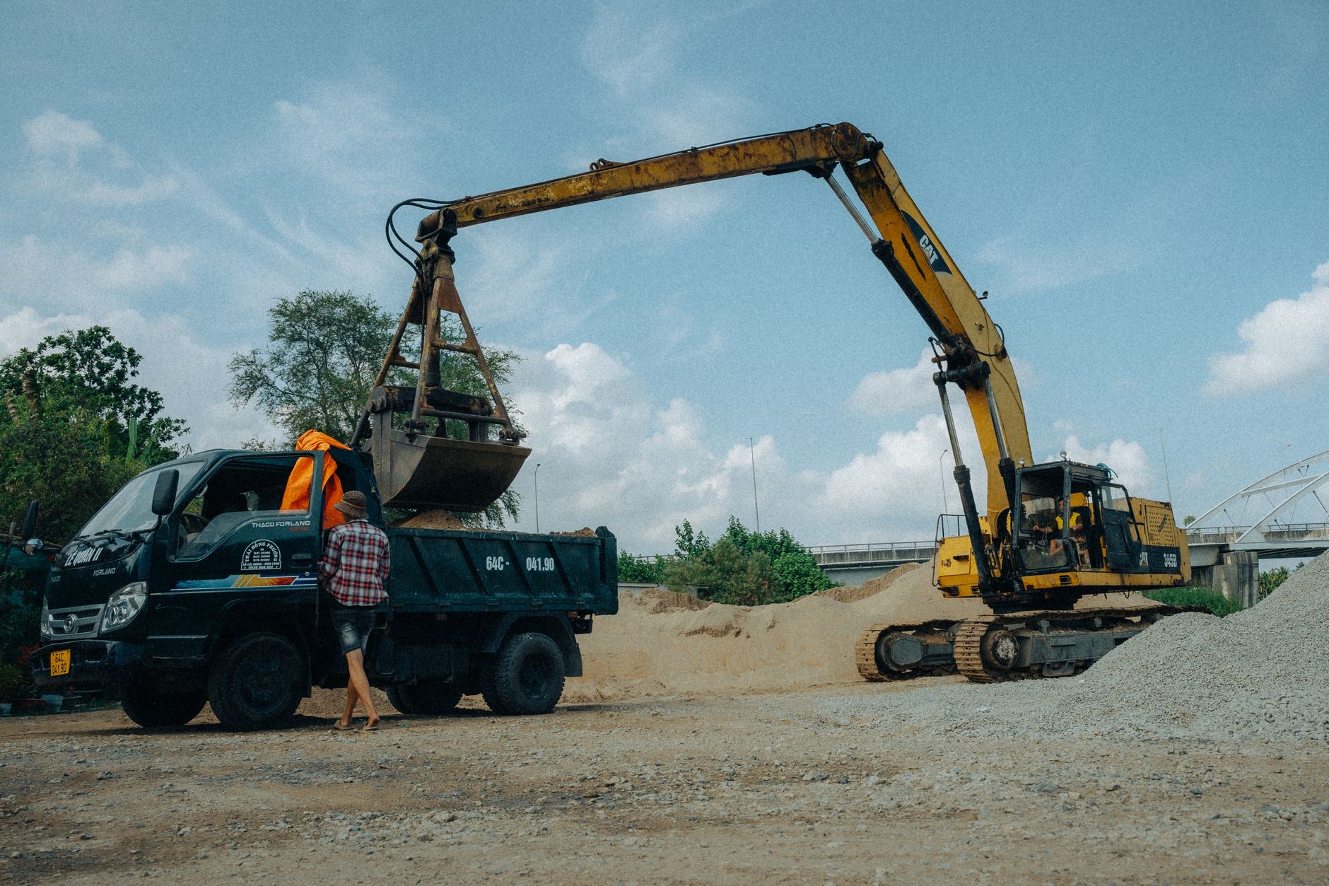 Mini excavator being hauled away on a rollback