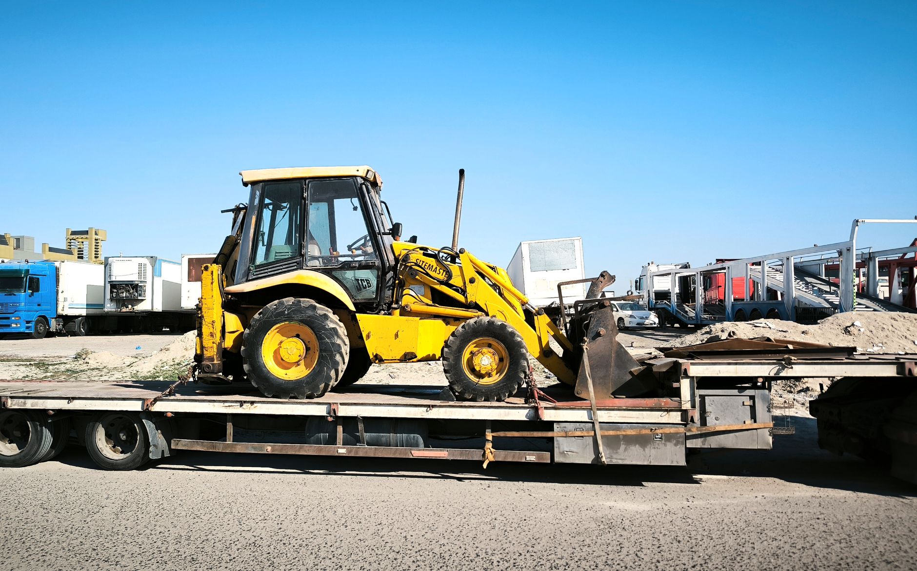 Gooseneck trailer being hauled on a rollback