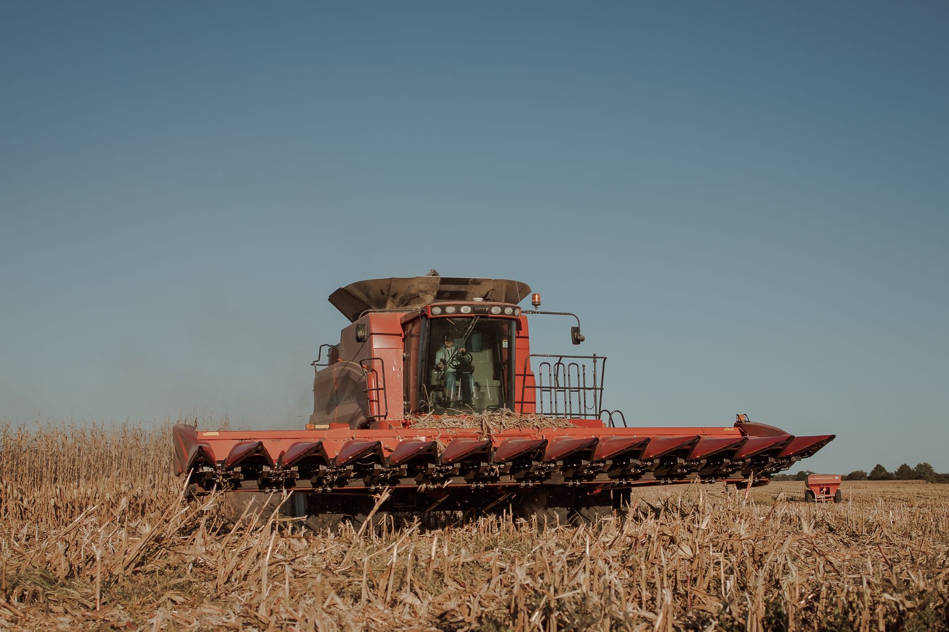 Grain header and corn head attachment on a trailer