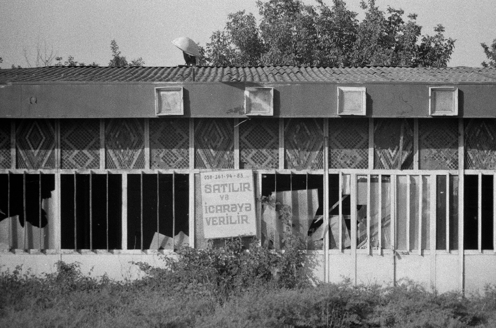 Storm-damaged trailer in a field